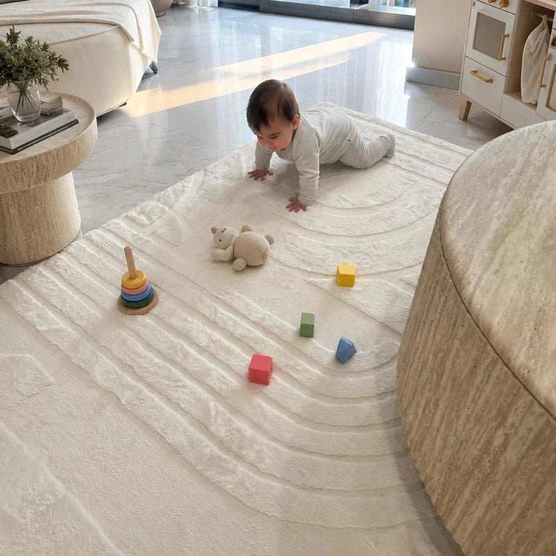 Playroom mat in cream with a soft textured pattern, cushioning a baby and toys on the floor