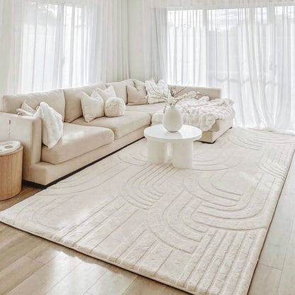 Modern living room with a Vanilla Cream Misk Mat and sectional sofa, coffee table.