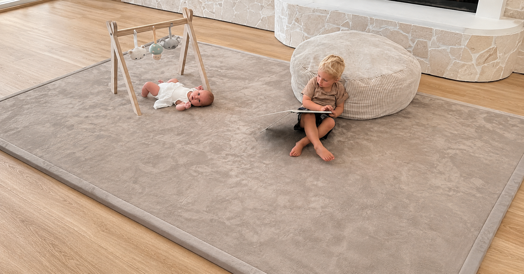 Two children playing on a Misk Mat 35mm memory foam mat in a modern living room — baby-safe, non-slip, and OEKO-TEX certified