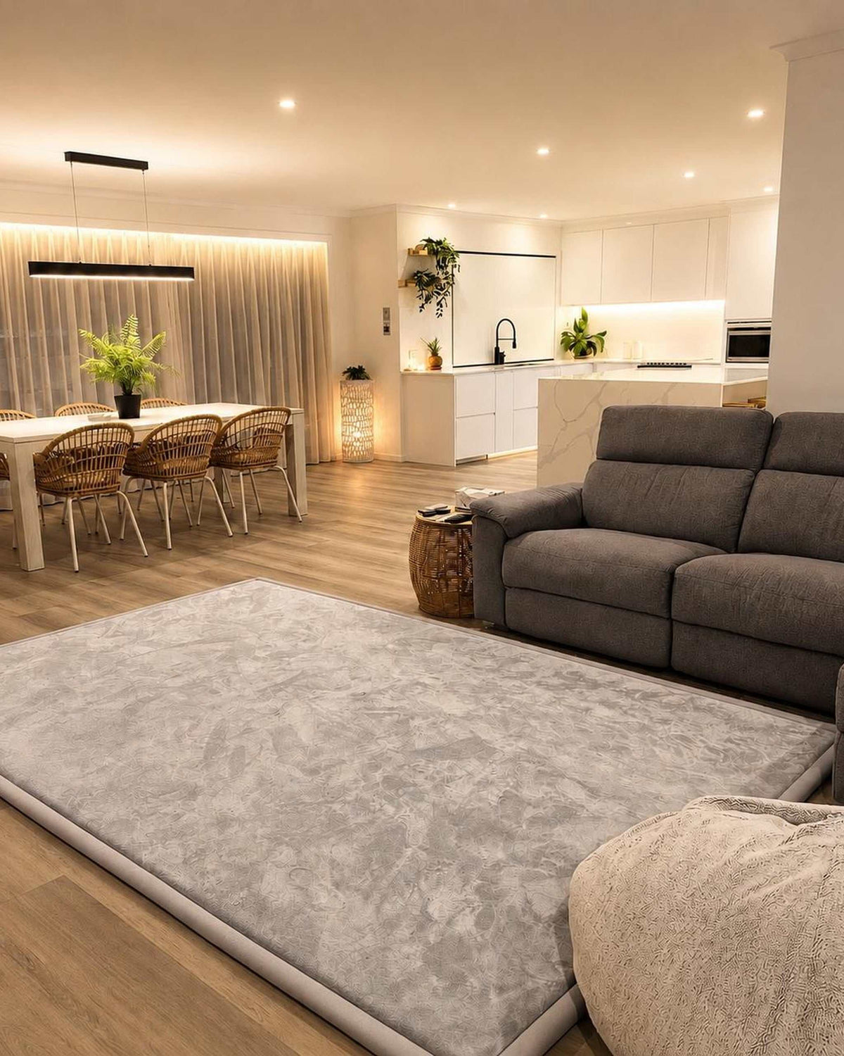 Dark Grey Misk Mat 35mm memory foam mat in an open-plan living and dining space with a grey sofa and kitchen island.