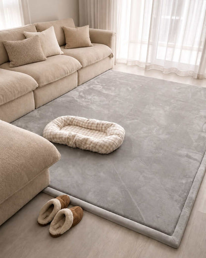 Light Grey Misk Mat 35mm memory foam mat in a living room with a beige sofa, pet bed and a pair of slippers.