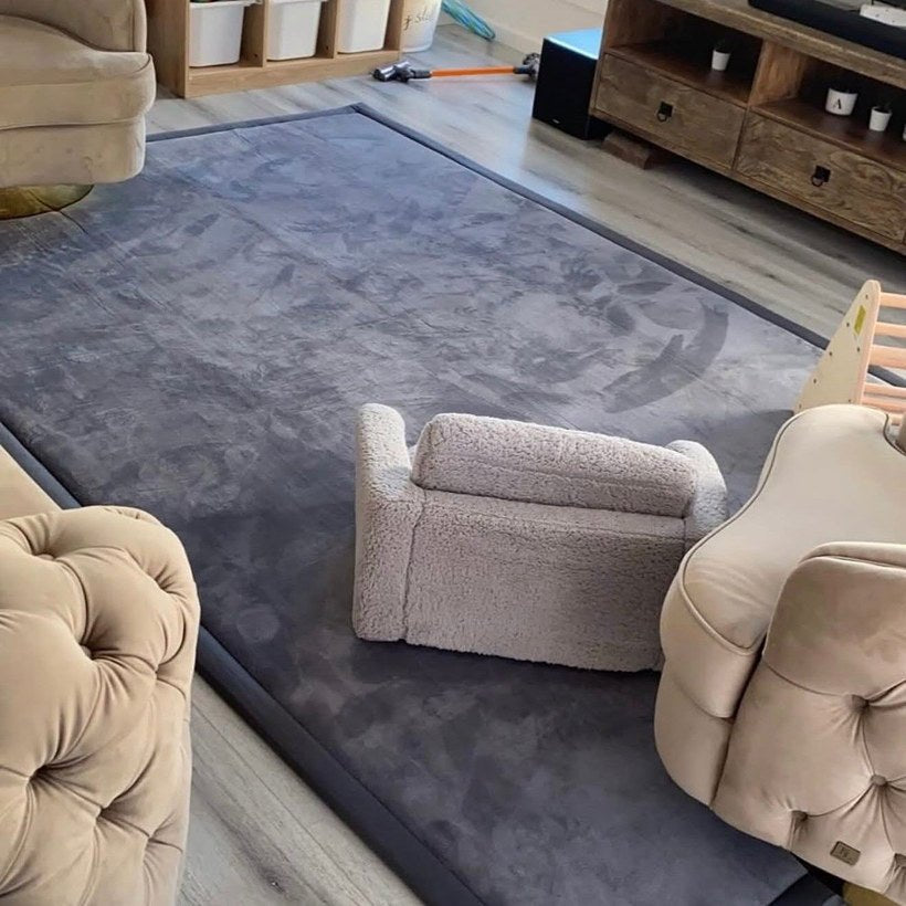 Dark grey memory foam carpet in a Dubai living room with kids couch