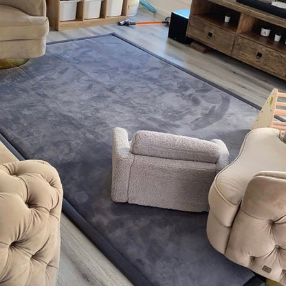 Dark grey memory foam carpet in a Dubai living room with kids couch