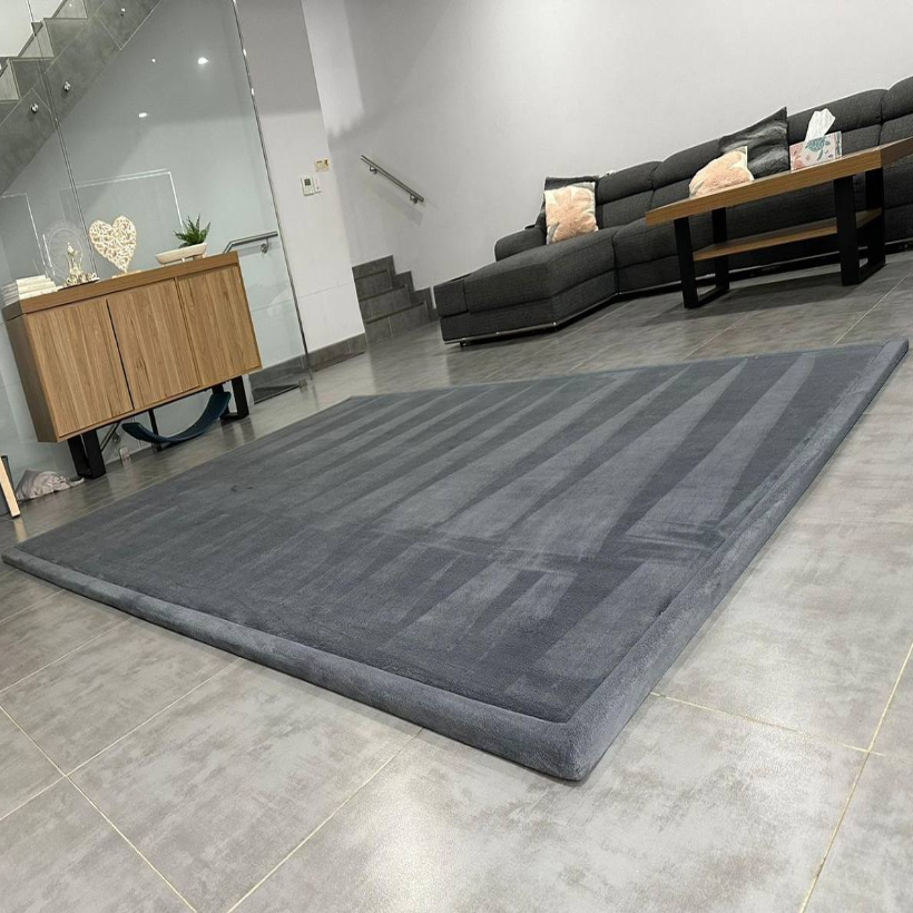 Dark grey memory foam carpet in a modern UAE living room – soft, non-slip, baby-safe play mat by Misk Mat